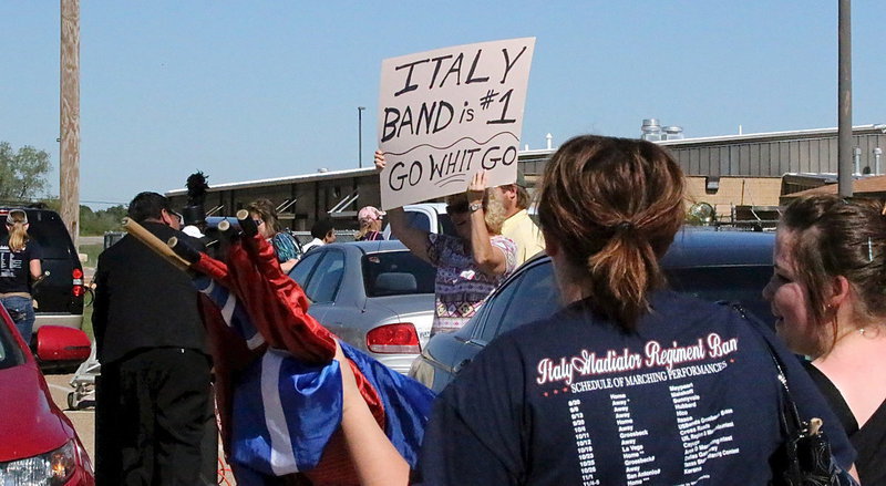 Image: The moment you transform from a high school band to rock stars! Band Director Jesus Perez, color guard sponsor Amber Droll and the rest of the band are treated like celebrities after exiting the field.