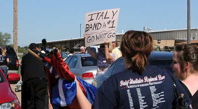 Image: The moment you transform from a high school band to rock stars! Band Director Jesus Perez, color guard sponsor Amber Droll and the rest of the band are treated like celebrities after exiting the field.