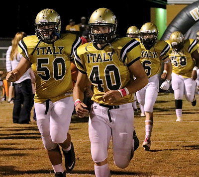 Image: Zain Byers(50), Coby Bland(40), Clayton Miller(6) and Darol Mayberry(58) charge out of the tunnel and onto the field.