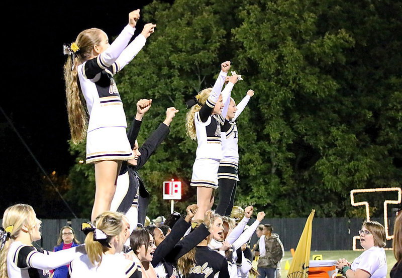 Image: Cheerleaders Karley Nelson, Taylor Boyd, Karson Holley and Britney Chambers get a lift from their fellow cheer mates.