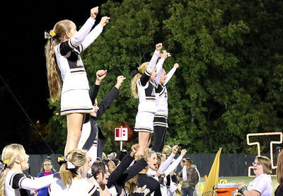 Image: Cheerleaders Karley Nelson, Taylor Boyd, Karson Holley and Britney Chambers get a lift from their fellow cheer mates.