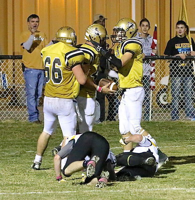 Image: Kyle Fortenberry(66) and Ryan Conor(7) congratulate Coby Bland(40) after he trucks a couple of Cayuga tacklers to score a touchdown.