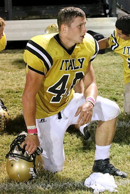 Image: Junior Coby Bland(40) takes a knee and a well deserved breather during an injury time-out.