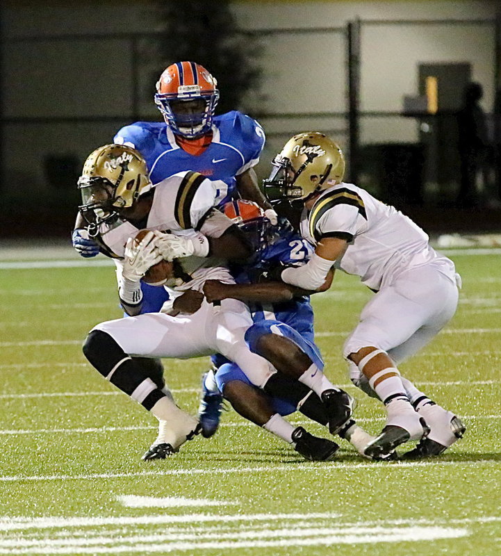 Image: Making the catch and then fighting for additional yardage is Trevon Robertson(3) with teammate Levi McBride(1) trying to loosen the Gator grip.