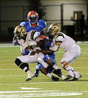 Image: Making the catch and then fighting for additional yardage is Trevon Robertson(3) with teammate Levi McBride(1) trying to loosen the Gator grip.