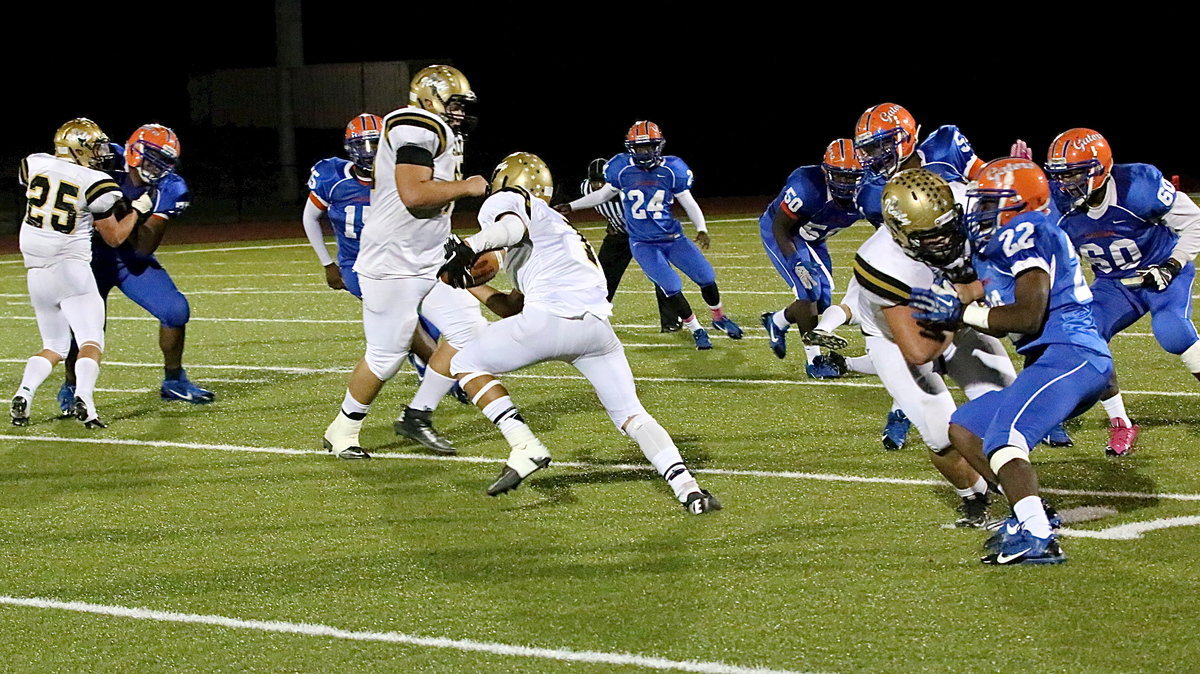 Image: Levi McBride(1) searches for daylight behind blockers Shad Newman(25), Kevin Roldan(60) and Zain Byers(50).
