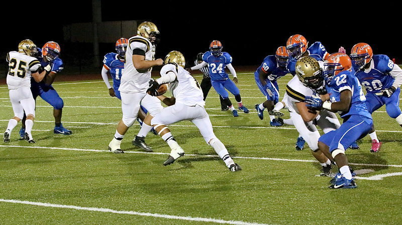 Image: Levi McBride(1) searches for daylight behind blockers Shad Newman(25), Kevin Roldan(60) and Zain Byers(50).
