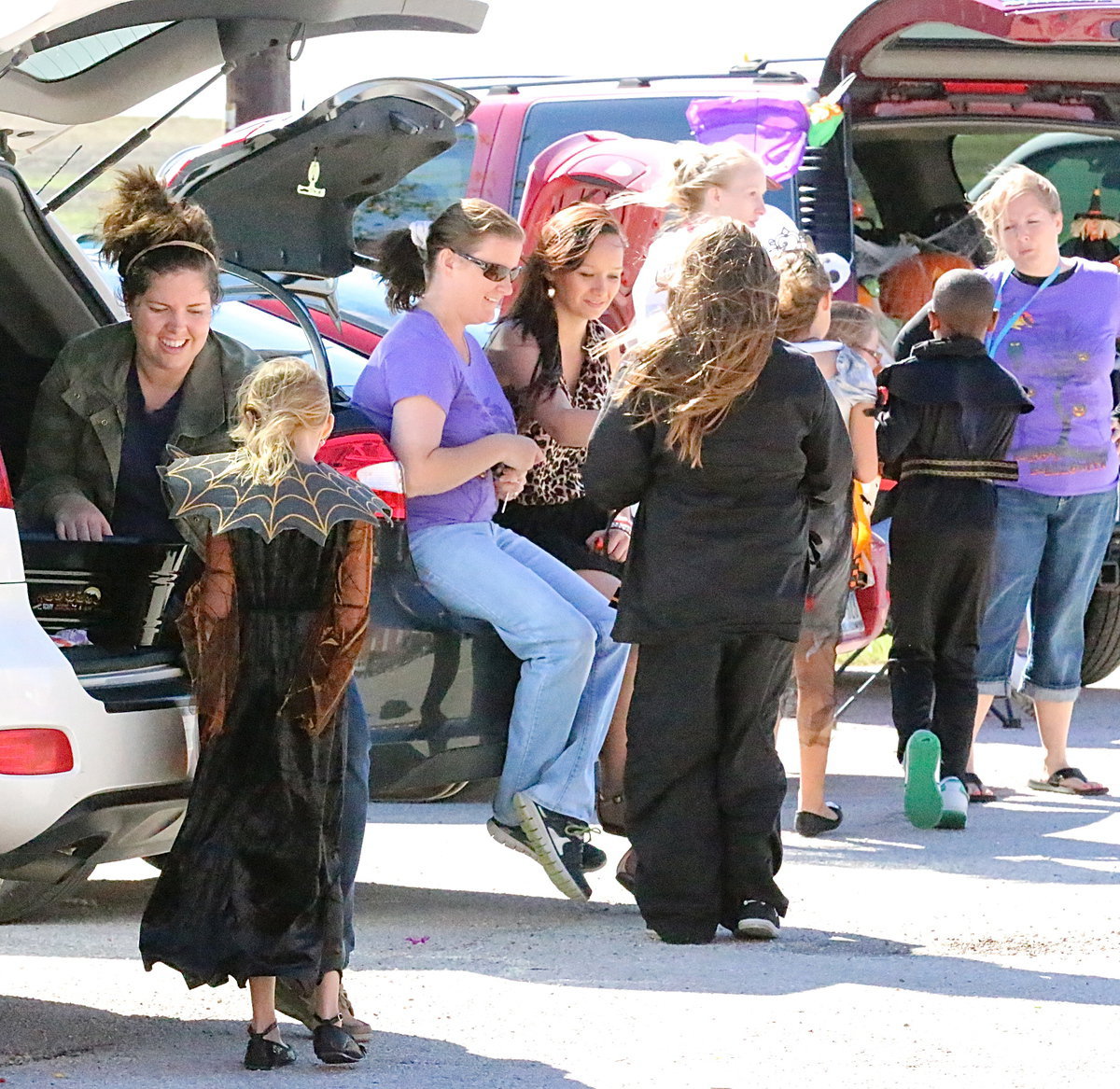 Image: Car after car passes out candy to the students.
