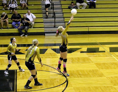 Image: Tara Wallis(5) and Jaclynn Lewis(13) backup Madison Washington(10) who returns the ball back over the net.
