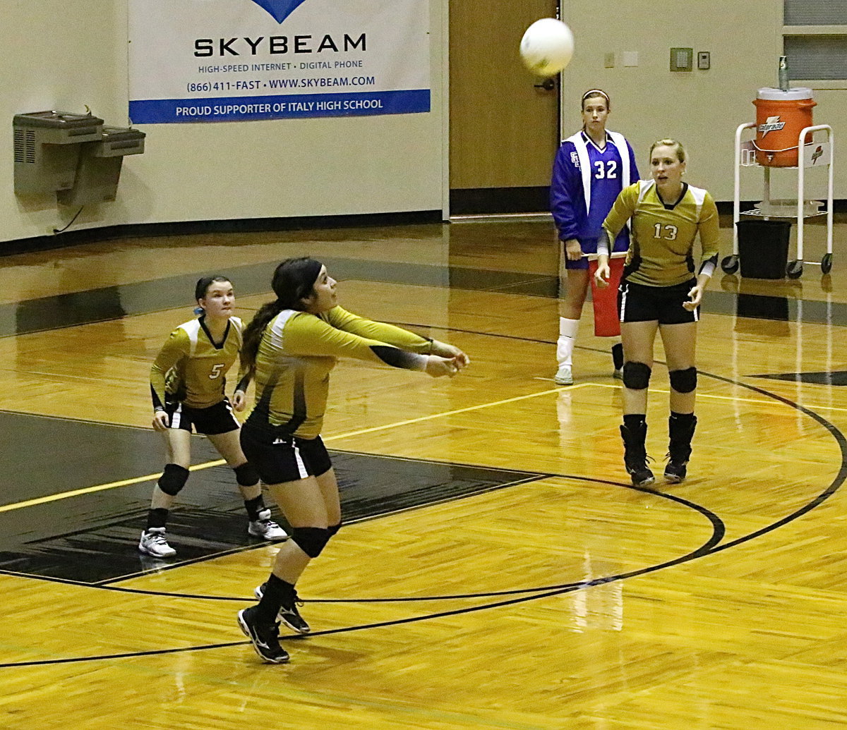 Image: Senior Monserrat Figueroa(15) bumps the ball up for teammates with Tara Wallis(5) and Jaclynn Lewis(13) ready to react.