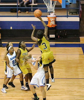 Image: Kortnei Johnson(3) is hard to stop as teammate Taleyia Wilson(22) moves in to rebound.