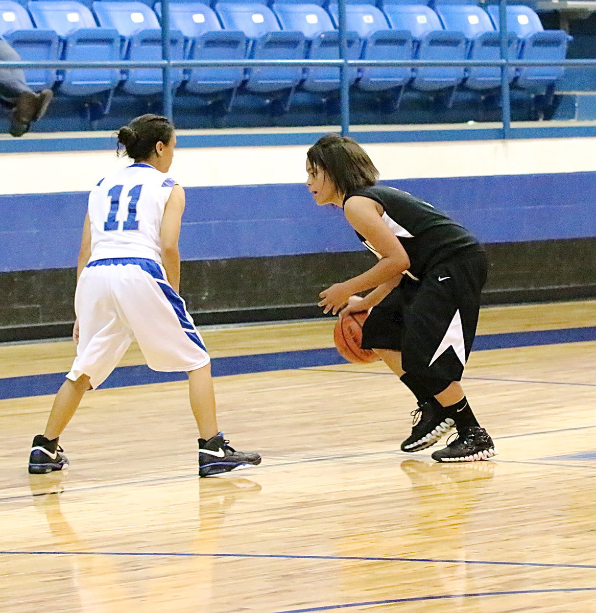 Image: Alex Minton(8) dribbles around a BG defender.
