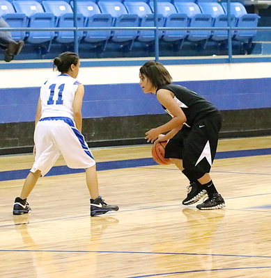 Image: Alex Minton(8) dribbles around a BG defender.