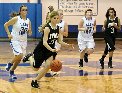 Image: Halee Turner(5) dribbles away from Blooming Grove defenders.