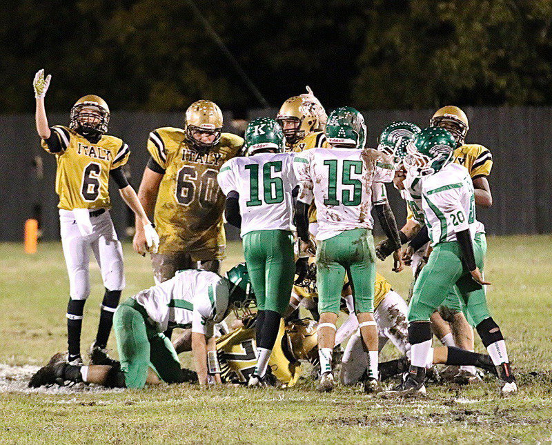 Image: Senior special teams extraordinaire Cody Medrano(75) recovers a Kevin Roldan(60) onside kick as Clayton Miller(6) and Coby Bland(40) signal Italy’s ball.