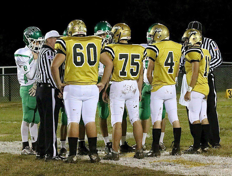 Image: Gladiator senior captains Kevin Roldan(60), Cody Medrano(75), Justin Wood(4) and Tyler Anderson(11) take part in the pre-game coin toss.