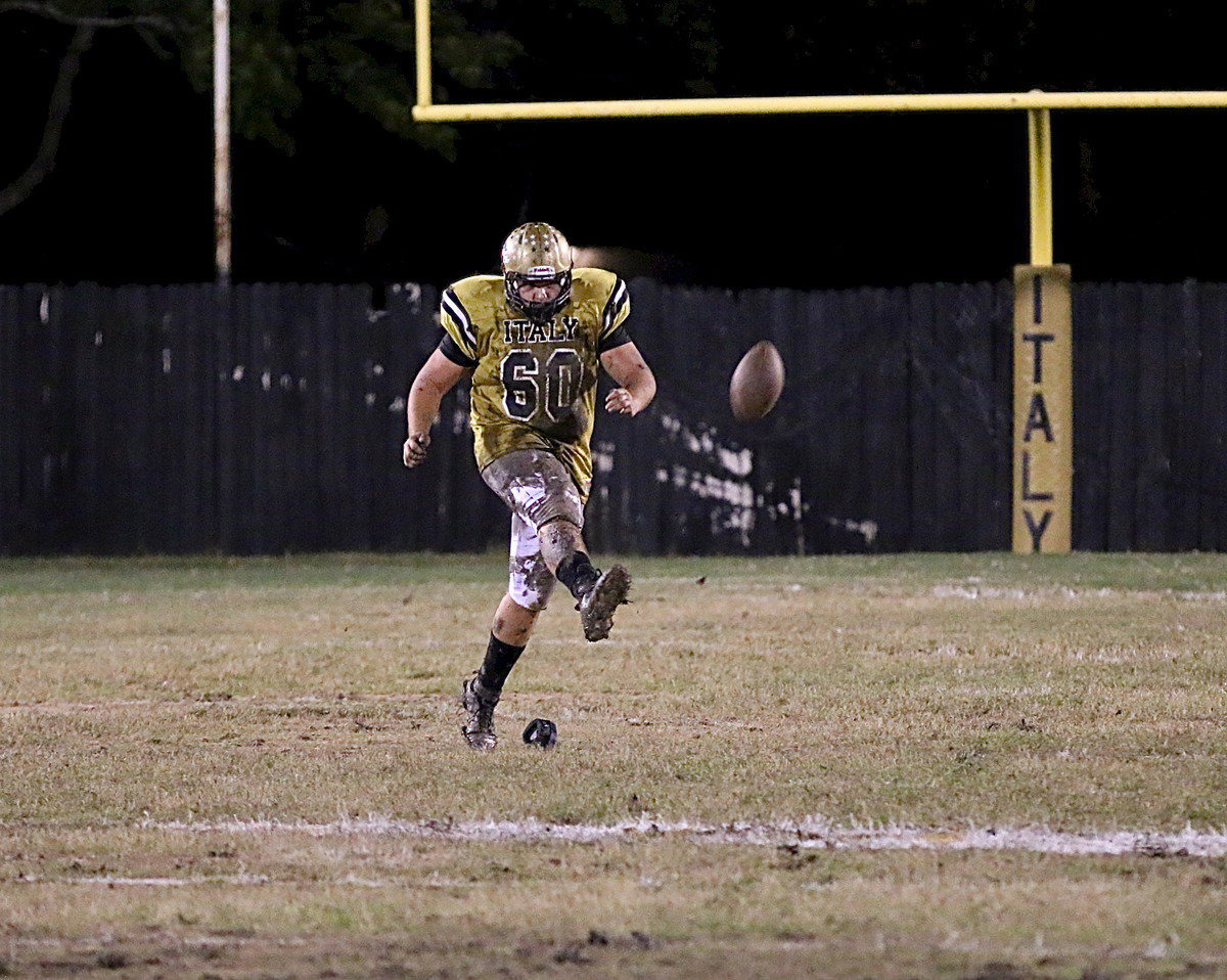 Image: Senior kicking ace Kevin Roldan(60) toes a hard to handle kickoff that is recovered by teammate Cody Medrano(75).