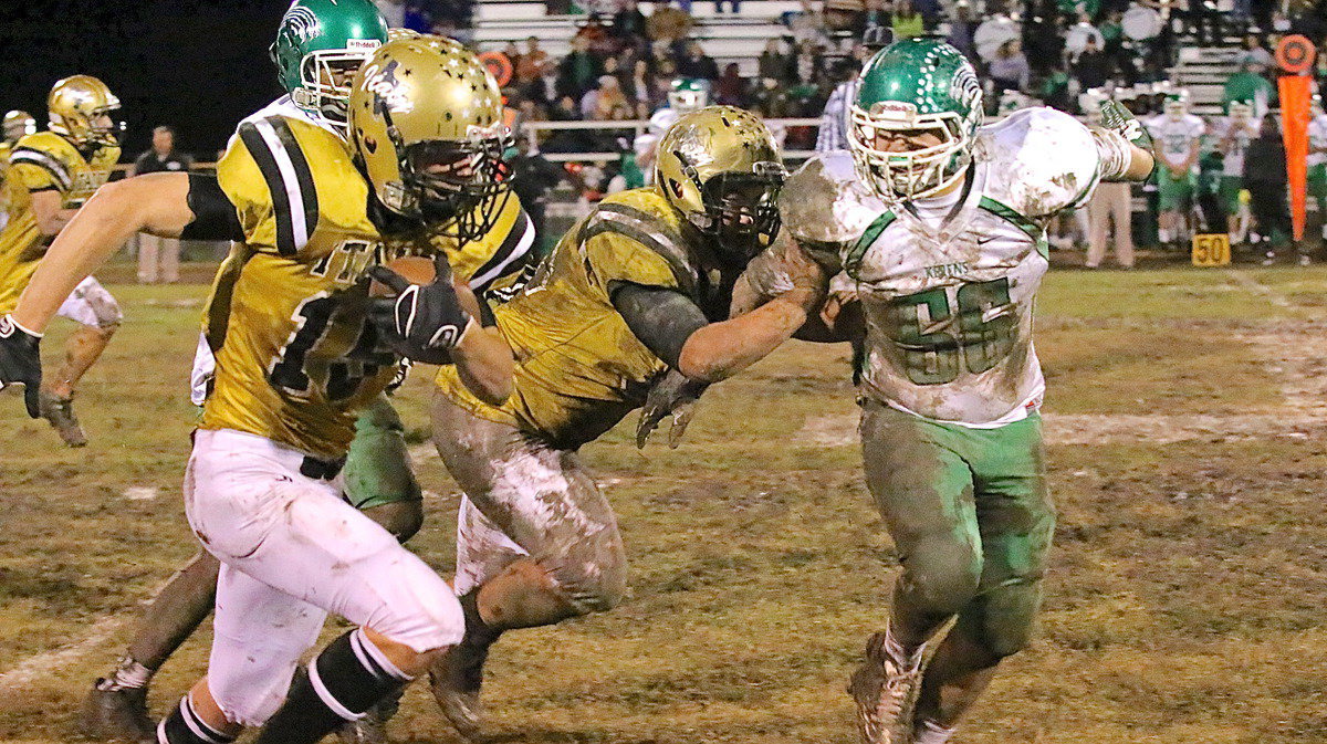 Image: Senior guard Zain Byers(50) hustles downfield to throw a block for junior tight end/receiver Cody Boyd(15) who reaches the first down marker.
