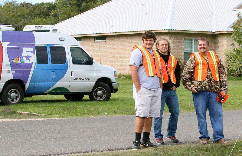 Image: Senior volunteers Kevin Roldan and Shad Newman assist Italy FFA teacher Blake Godwin with traffic control around the school.