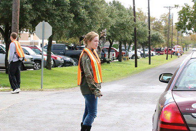 Image: Italy HS seniors Bailey Walton and Taylor Turner leap into action to direct incoming traffic to their school from neighboring communities who are wishing to seek shelter after being evacuated from their homes.