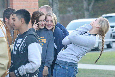Image: Jozie Perkins and Hannah Washington cheese it up on bi-district burger day while Maddy Washington opts out of this photo…almost.