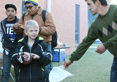 Image: School board member Sal Ramirez whips up some seasoned french fries for Dustin Duke, Jorge Salazar and Marcos Duarte.
