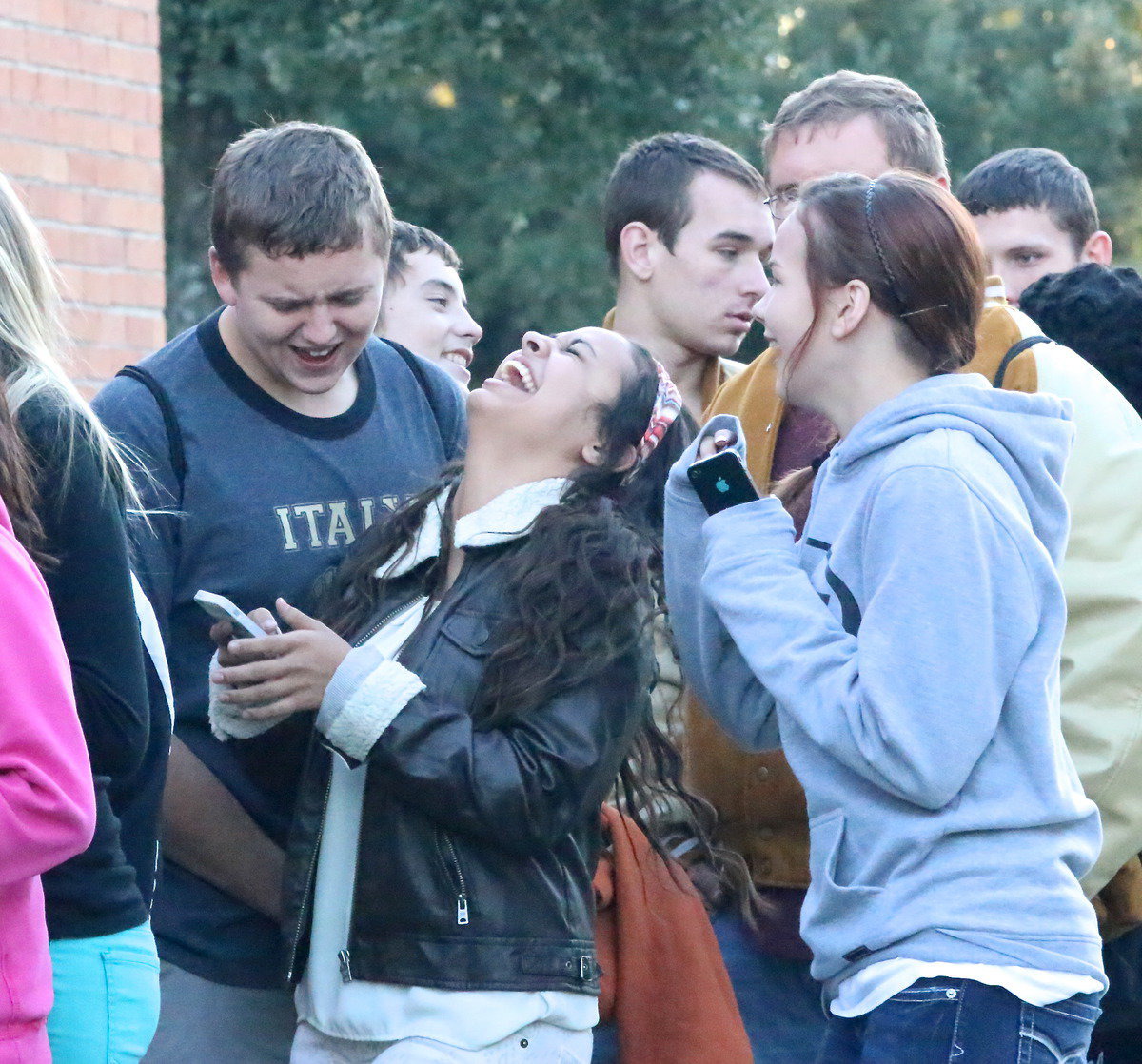 Image: Gladiator Bailey Walton and cheerleaders Ashlyn Jacinto and Paige Little share a laugh while waiting in the food line.