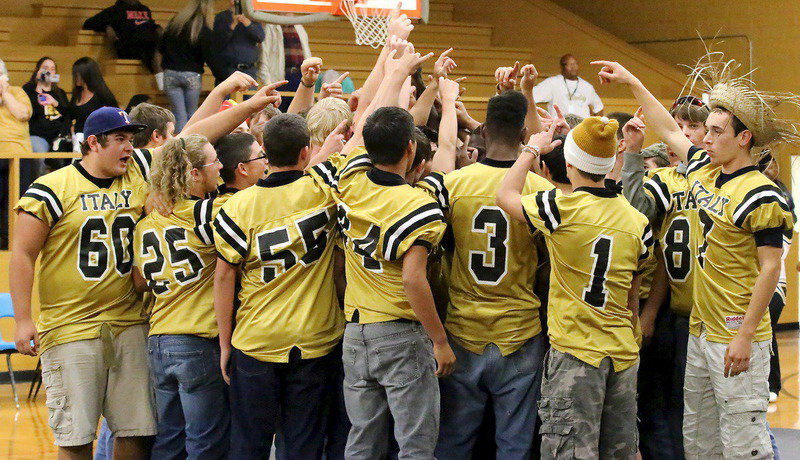 Image: A team huddle wraps up the pep rally.