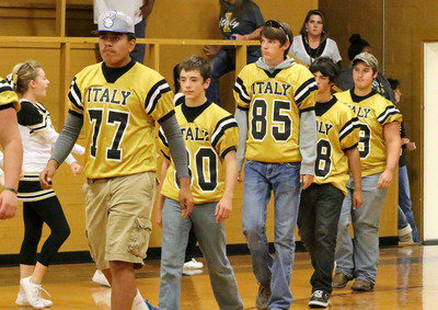 Image: Britney Chambers and the rest of the cheerleaders form a spirit line as David De La Hoya, Dylan McCasland, Ty Windham, Elliott Worsham and Samuel Corley enter the gym.