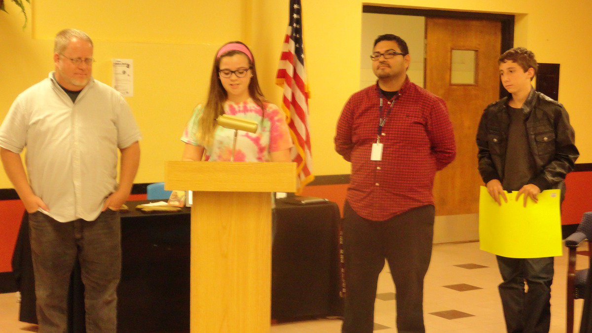 Image: Reagan Adams and Noah Ramirez present David Graves and Jesus Perez, band directors, with tickets to the upcoming Dallas Cowboy game at Monday night’s school board meeting.