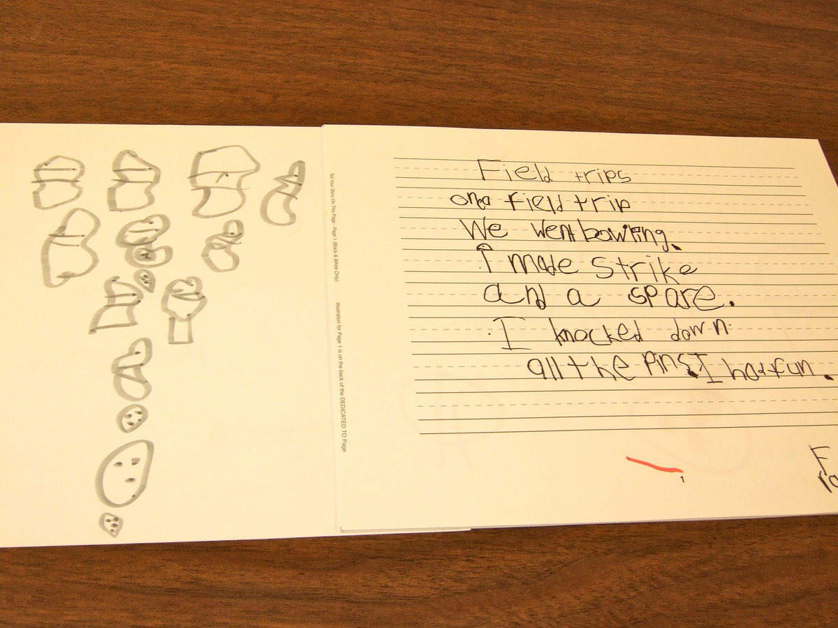 Image: Frankie South shows us his story and illustration for his class book about field trips.