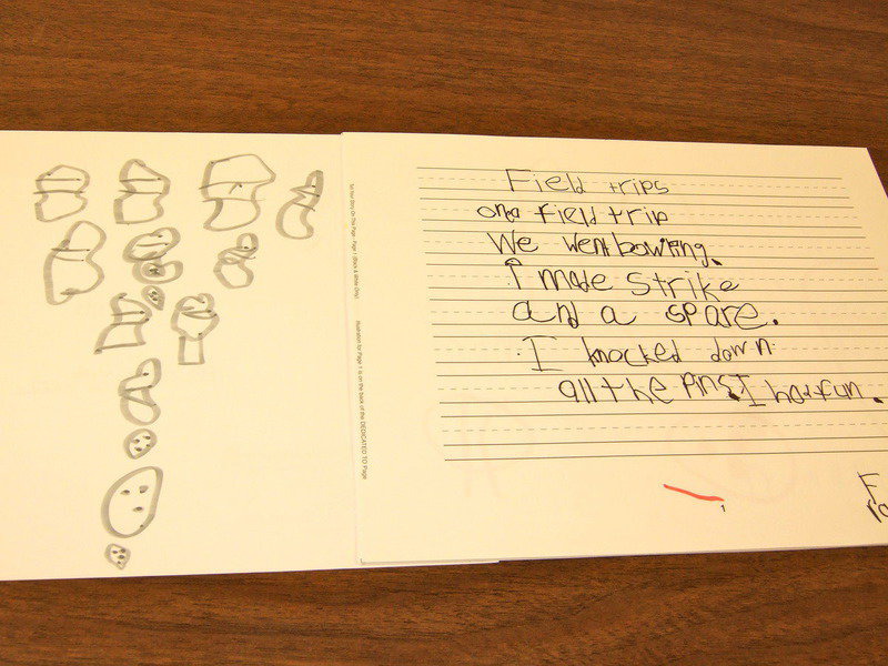 Image: Frankie South shows us his story and illustration for his class book about field trips.