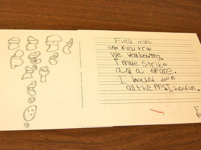 Image: Frankie South shows us his story and illustration for his class book about field trips.