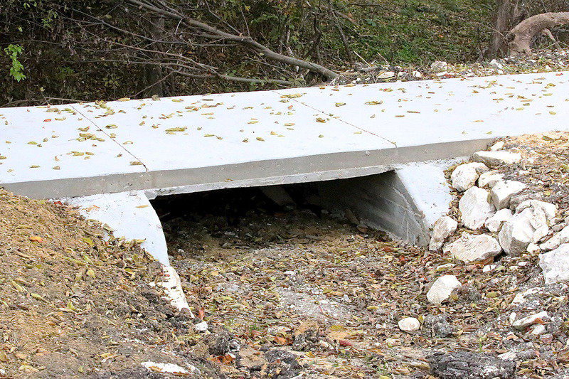 Image: A scenic little bridge allows water to drain from the fields to a nearby creek without disturbing the flow of trail traffic.