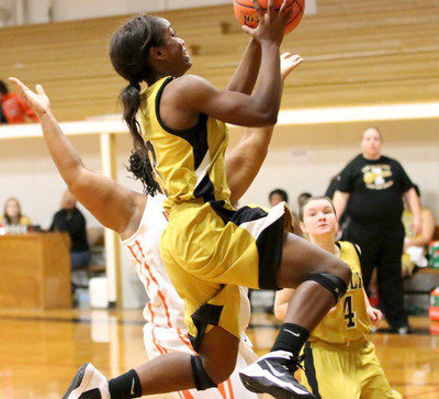 Image: Kortnei Johnson(3) attacks the rim.