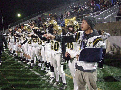 Image: Gladiators Joseph Celis(2), Kyle Fortenberry(66) and Dylan McCasland(3) join their teammates in signaling it’s time for the opening kickoff.