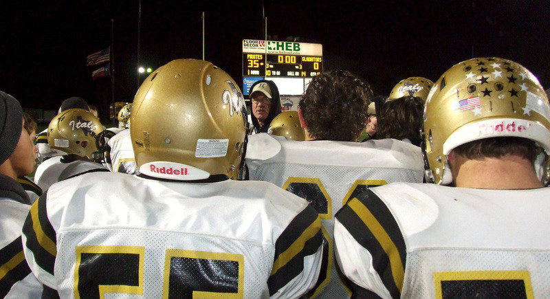 Image: Coach Tindol huddles one last time with his players after Collinsville stuns the Gladiators, 35-0, to take the area title.