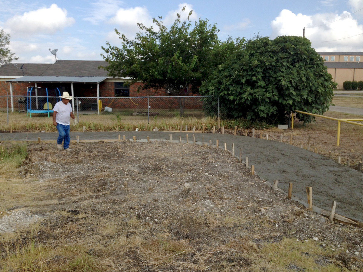 Image: A construction photo of the trail shows the wet concrete ready to be smoothed.