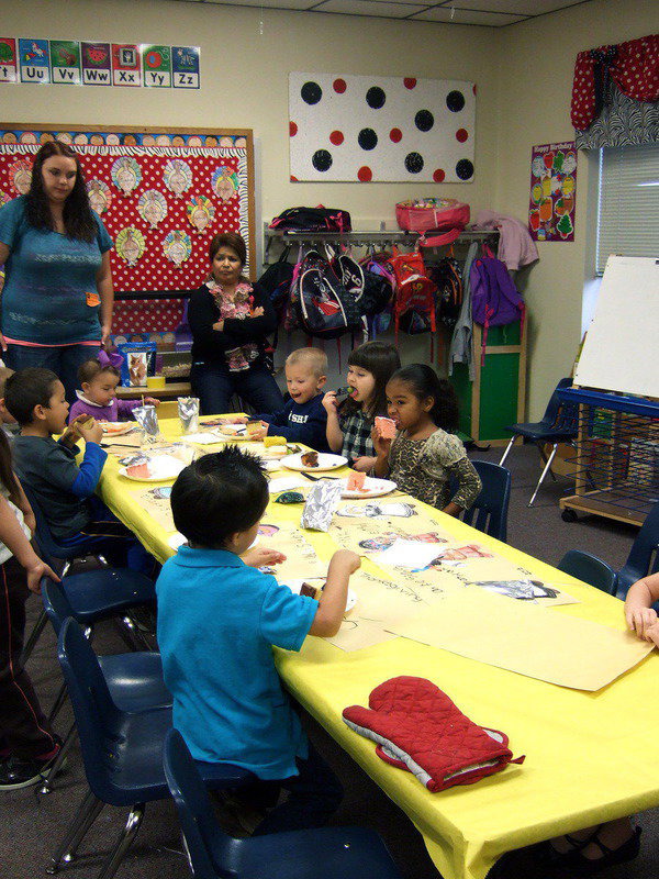Image: These pre-K students are really enjoying their dessert.