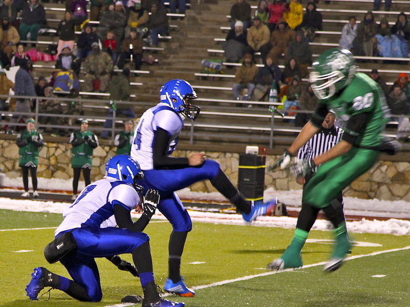 Image: Kicker Joseph Salazar kicks the field goal before it can be blocked.