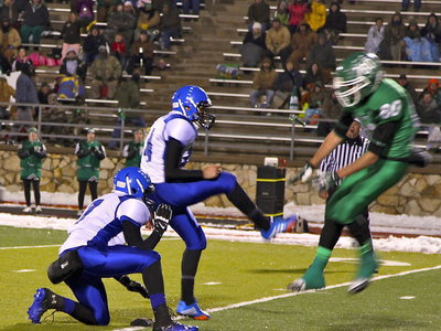 Image: Kicker Joseph Salazar kicks the field goal before it can be blocked.
