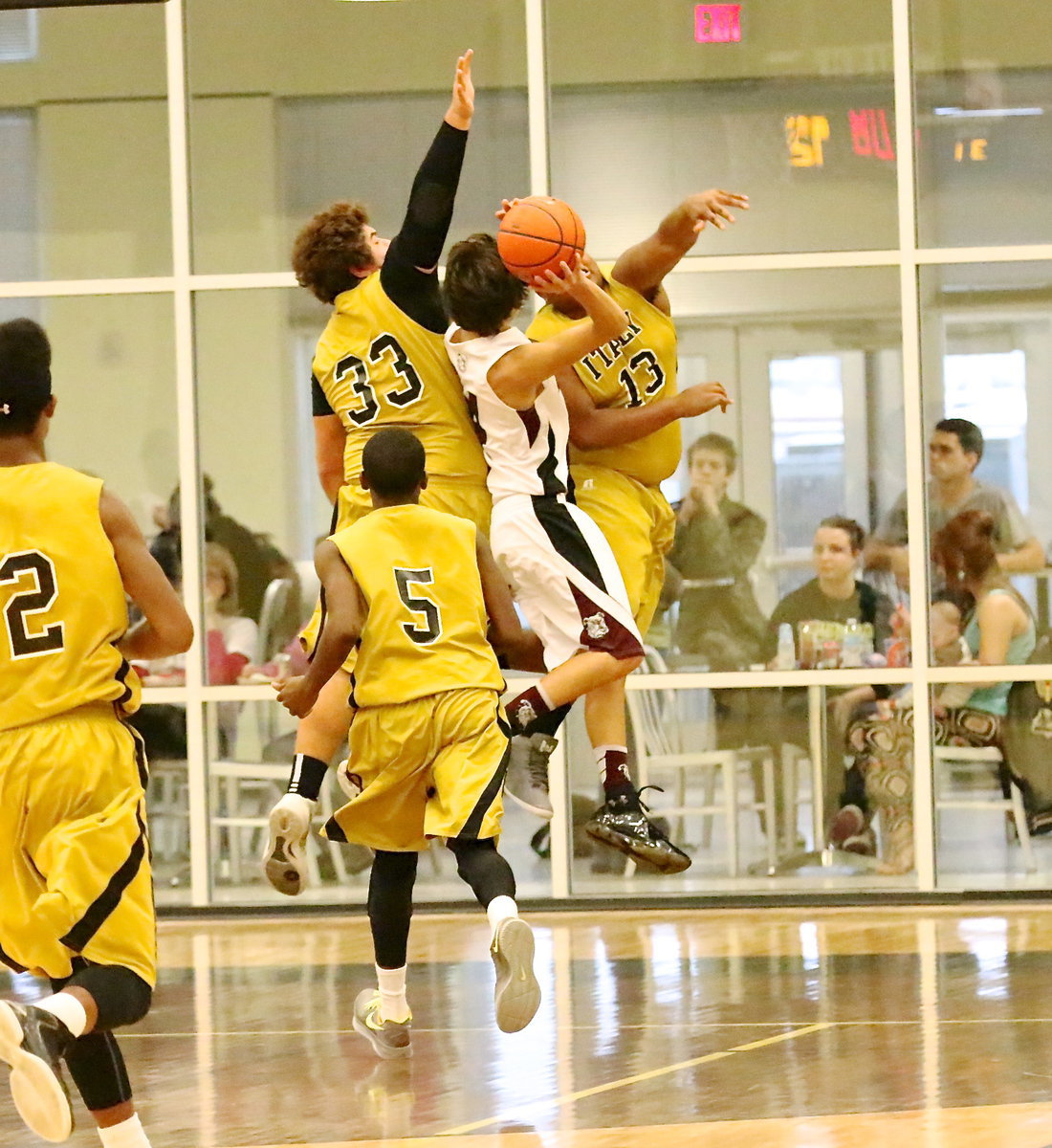 Image: Kevin Roldan(33) and Darol Mayberry(13) both go for the block.