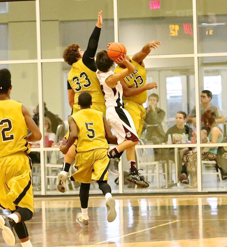 Image: Kevin Roldan(33) and Darol Mayberry(13) both go for the block.