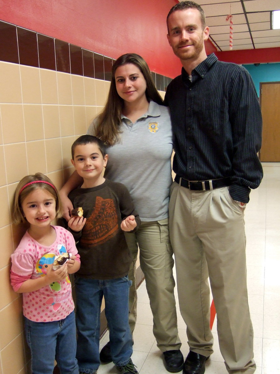 Image: Happy family sharing donuts.