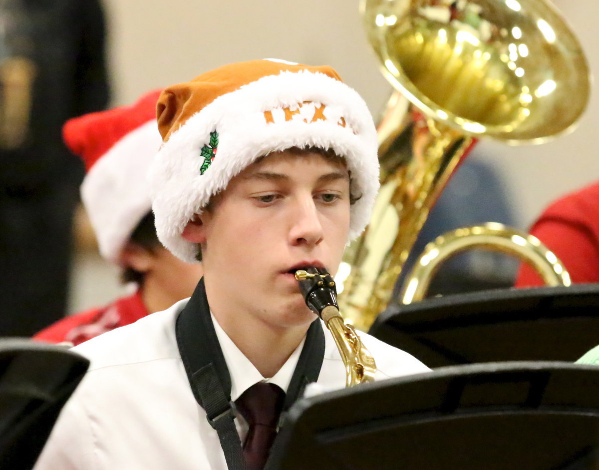 Image: Michael Moore gets into the holiday spirit with his saxophone.