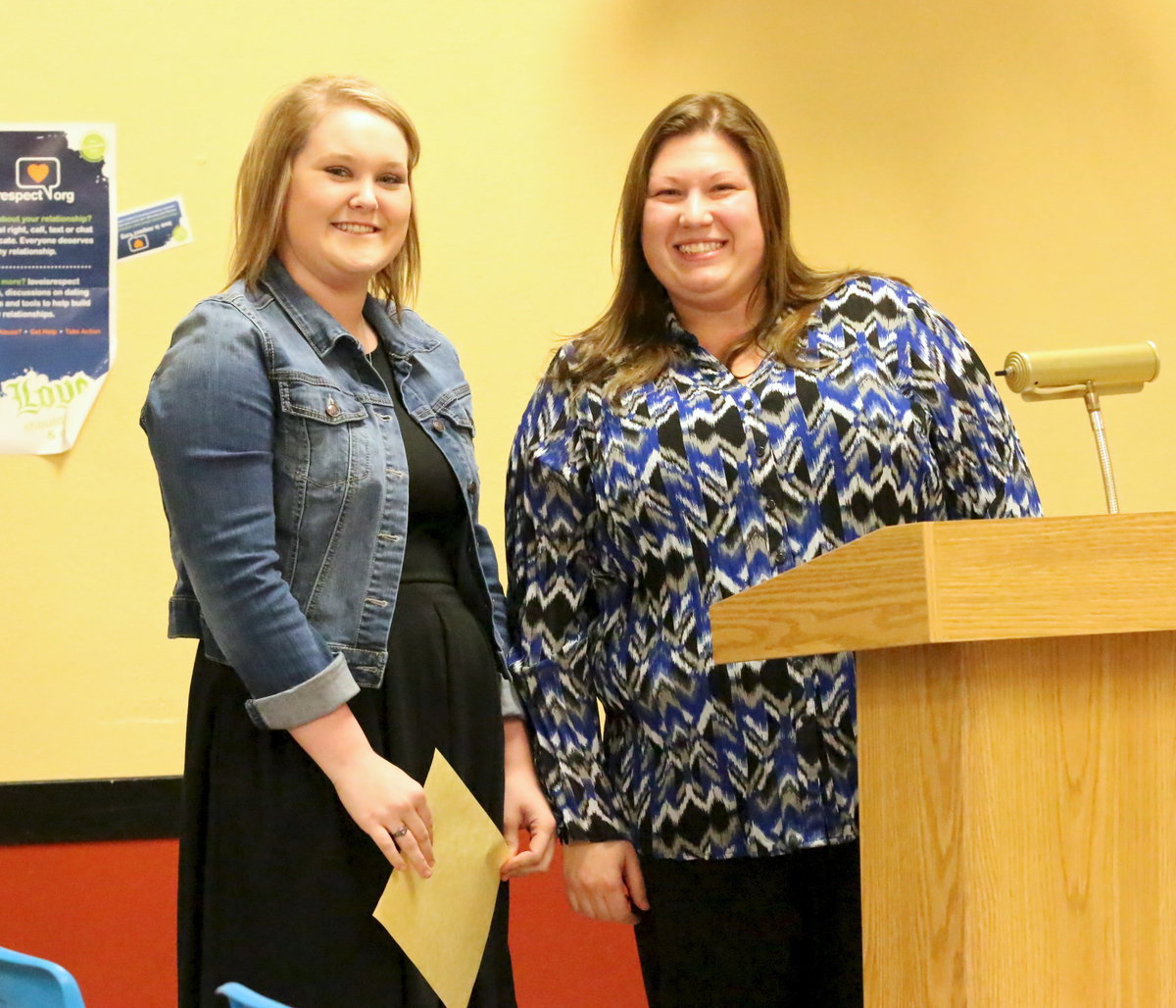 Image: Jesica Wilkins accepts her certificate of accomplishment with a smile from Counselor Erica Miller. Wilkins graduated cosmetology school before she graduated high school and already has a job!