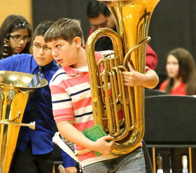 Image: Brennon Sigler and Michael Gonzalez hoist their tubas high in triumph.