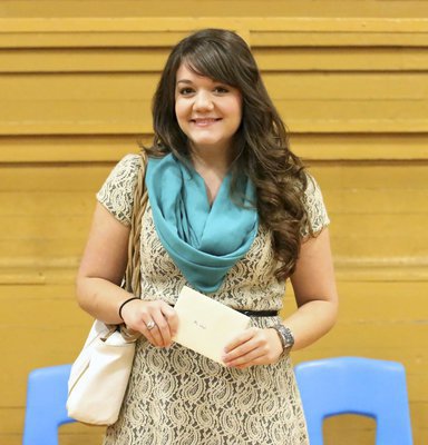 Image: Student band teacher Cherry Lloyd is presented with a gift from Jesus Perez, David Graves and the entire cast of the Gladiator Regiment Band members.