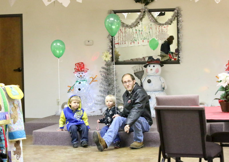 Image: Grandkids of Meg Lyons, Noah and Jonah along with family friend,  take a break in the action.