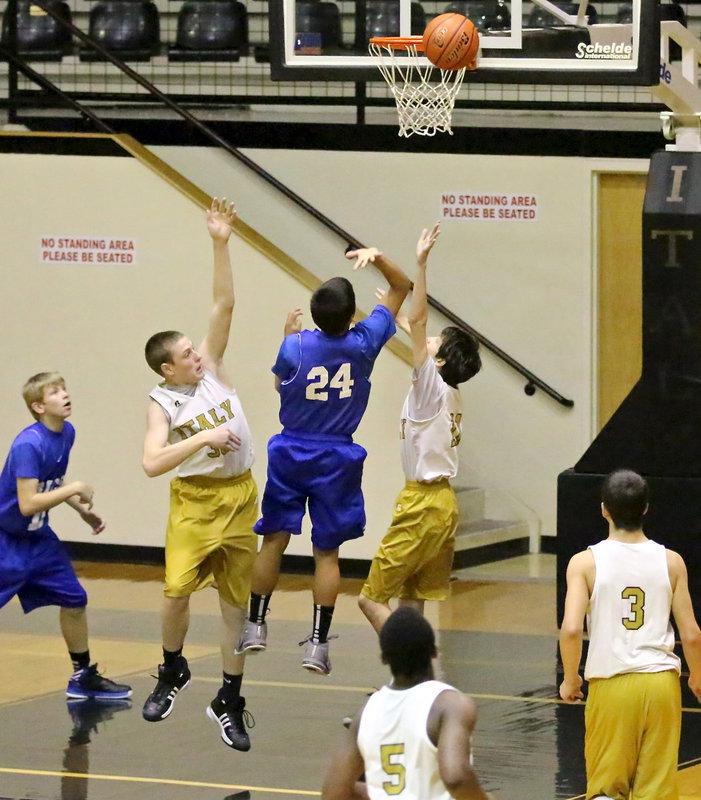 Image: Clay Riddle(30) and teammate Ty Hamilton(11) put pressure on a Rice shooter.